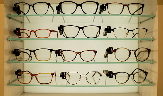 Glasses arranged in different categories on shelves with a varied offer